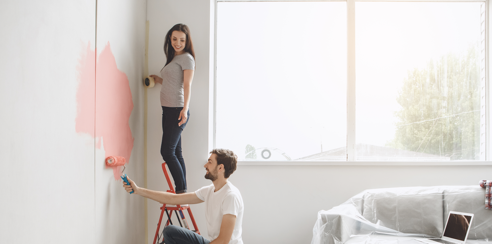 couple painting wall together